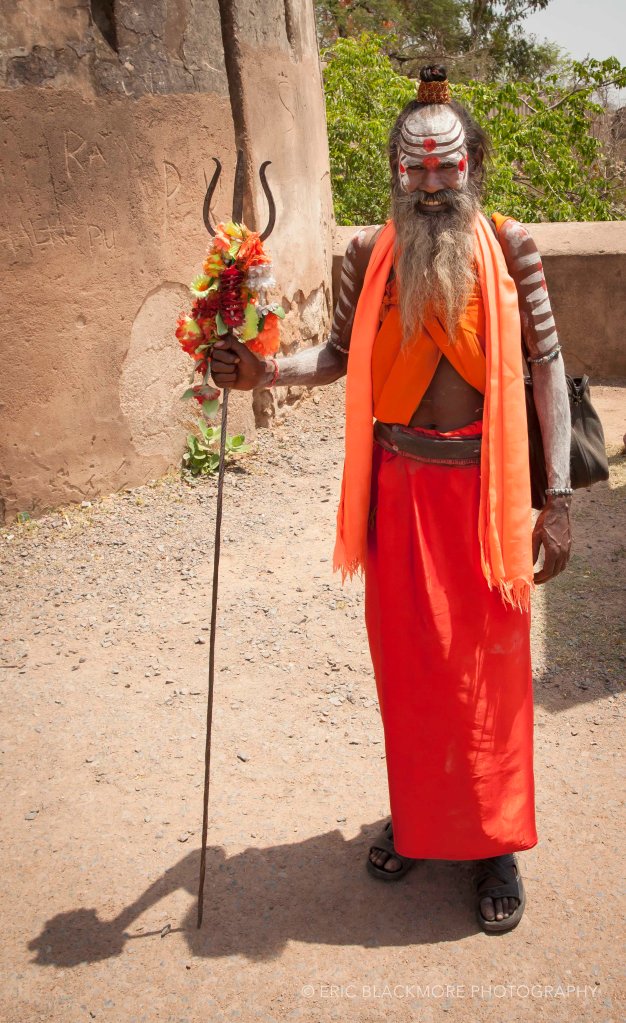 A Brahmin in traditional dress posing for photographs.
